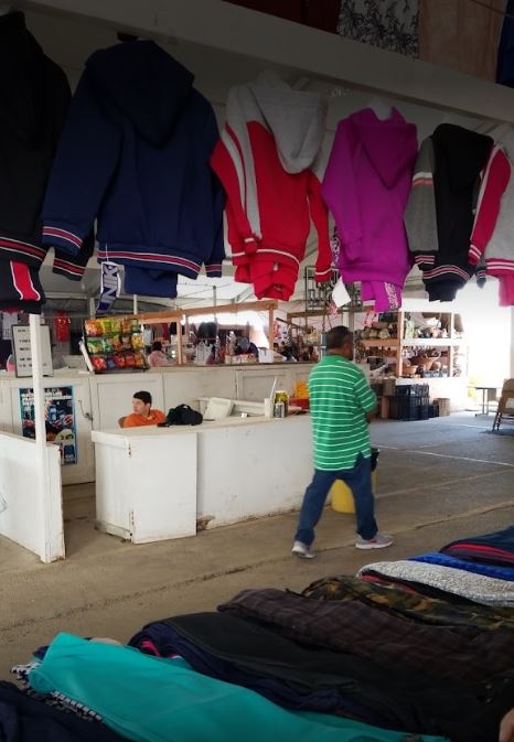 man walking through flea market isle